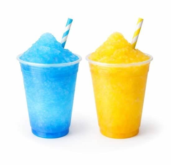 Colorful blue and yellow slush drinks in cups with straws, perfect for summer treats.